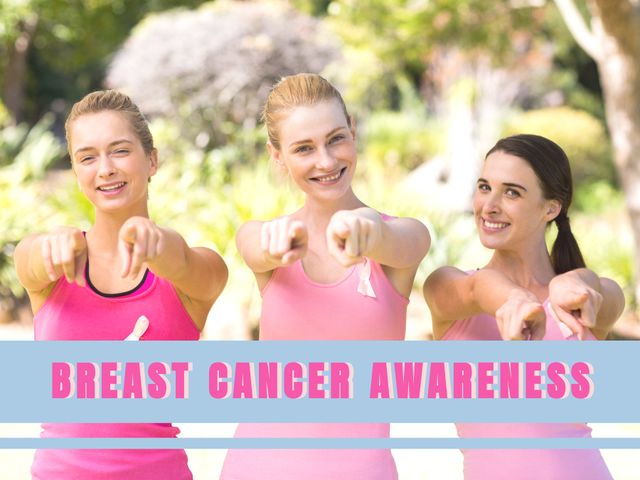 Image captures three women wearing pink shirts, pointing towards the camera and smiling to promote breast cancer awareness. Ideal for use in campaigns, websites, and social media posts supporting breast cancer research and awareness initiatives. Highlights themes of unity, positivity, and community action to fight breast cancer.