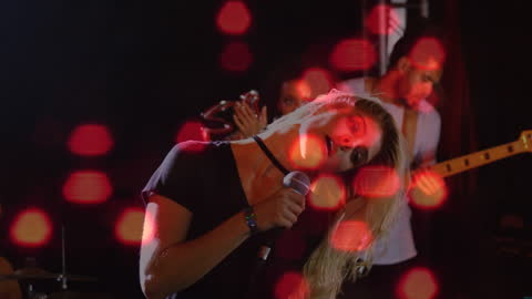 Energetic Performance by Singer with Vibrant Lighting Effects