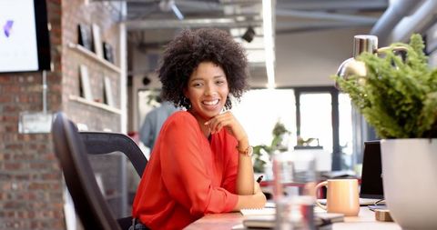 Confident entrepreneur in modern office setting with bright workspace