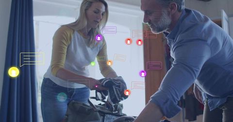 Couple packing duffel with social message overlays showing digital communication at home