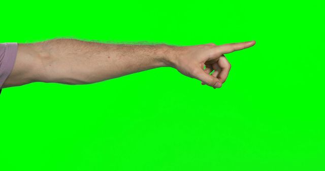 A Caucasian male hand is extended with the index finger pointing to the right, against a green screen background, with copy space. The gesture could be used to direct attention or indicate an object or direction in visual content.