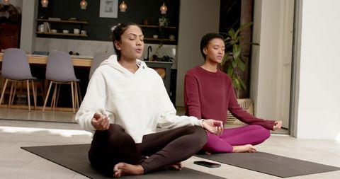 Diverse Female Friends Meditating in Calm Home Environment