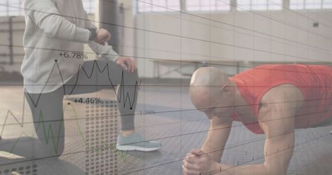 Man planks at gym while coach tracks performance with data overlay