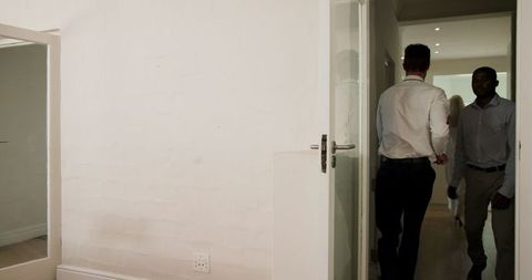 Bride and groom celebrating wedding ceremony at home with friends