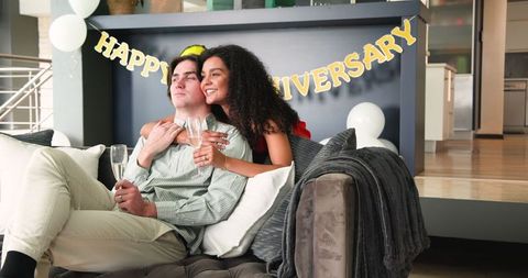 Joyful couple toasting anniversary with champagne celebration