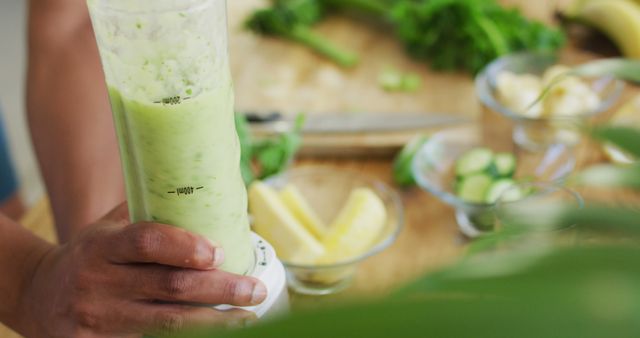 Close-up Hand Holding Blender Making Fresh Green Smoothie - Download Free Stock Images Pikwizard.com