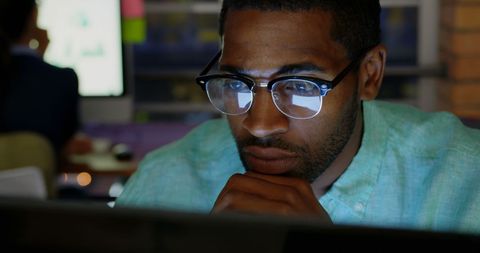 Focused African American Businessman Working Late in Modern Office