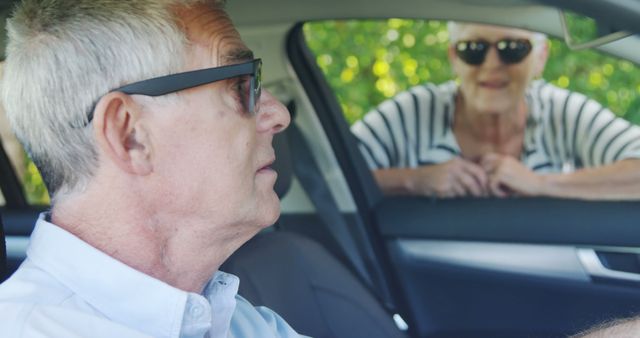 Senior Man Driving Car with Woman Outside Window - Download Free Stock Images Pikwizard.com