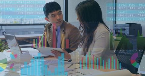 Business Professionals Analyzing Data with Digital Tools