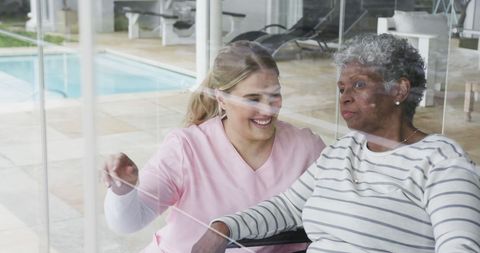 Caring Nurse Engaging with Senior Woman in Healthcare Setting