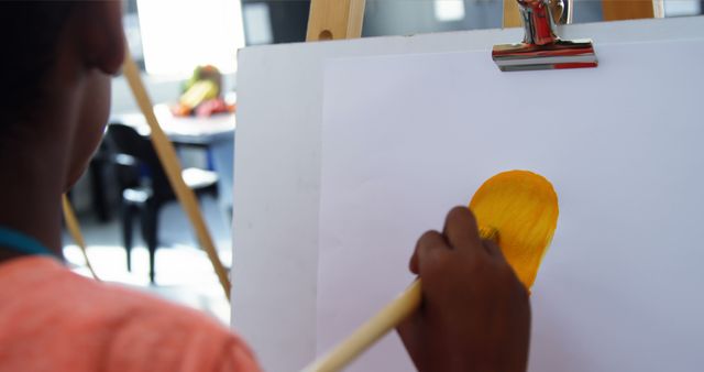 Close-up of artist painting yellow object on canvas - Download Free Stock Images Pikwizard.com