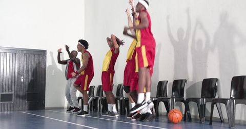 Enthusiastic Basketball Team Cheering on Gym Sideline
