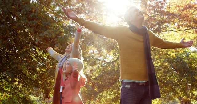 Happy Family Enjoying Autumn Sunlight Together Outdoors - Download Free Stock Images Pikwizard.com