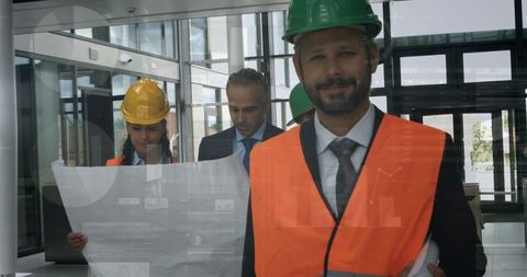 Confident Architects Analyzing Blueprints in Modern Office Setting - Download Free Stock Images Pikwizard.com