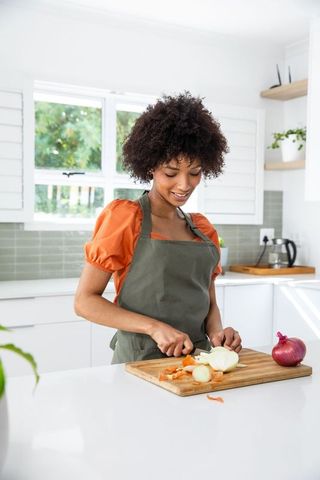 Smiling Woman Preparing Ingredients in Modern Kitchen
