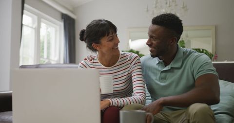 Happy Diverse Couple Enjoying Time Together with Laptop - Download Free Stock Images Pikwizard.com