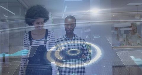 Two professionals interacting with holographic interface and tablet in modern workspace