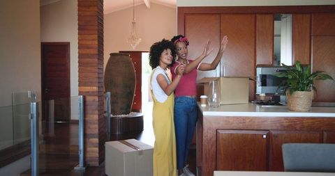 Diverse Couple Unpacking in New Home's Stylish Kitchen