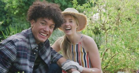 Joyful Diverse Couple Gardening Together on Sunny Day
