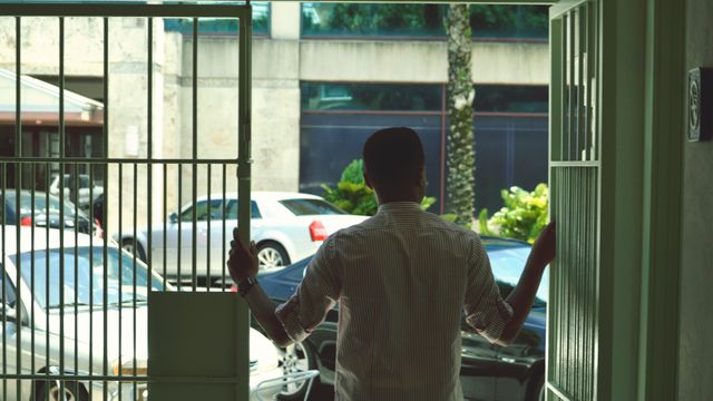 Businessman Exiting Office Building onto City Street during Daytime - Download Free Stock Images Pikwizard.com