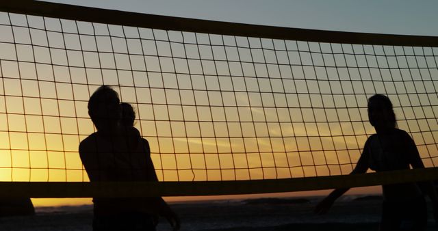 Silhouettes Playing Beach Volleyball at Sunset - Download Free Stock Images Pikwizard.com