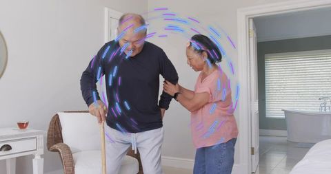 Senior partner supporting with cane in bedroom, caregiver helping mobility at home
