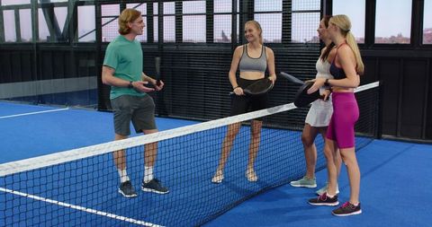 Friends Gather on Blue Paddle Court, Enjoying Active Sports Outdoors