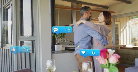 Mature couple embracing in sunlit open-plan kitchen with social media overlays