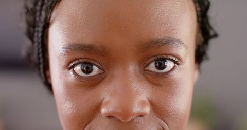 Close-up portrait african woman looking directly at camera with ring light reflection