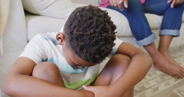 Sad african american boy sitting on floor and crying, in slow motion - Download Free Stock Photos Pikwizard.com