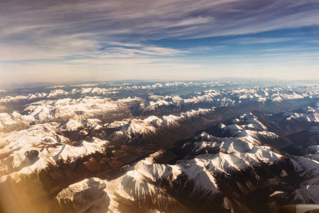 Breathtaking Aerial View of Snow-Capped Mountain Range and Valleys - Download Free Stock Photos Pikwizard.com