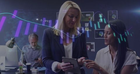 Business Women Analyzing Data in Modern Office Environment