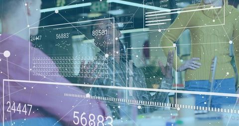 Tech team collaborating around augmented reality analytics dashboard with interactive data overlays