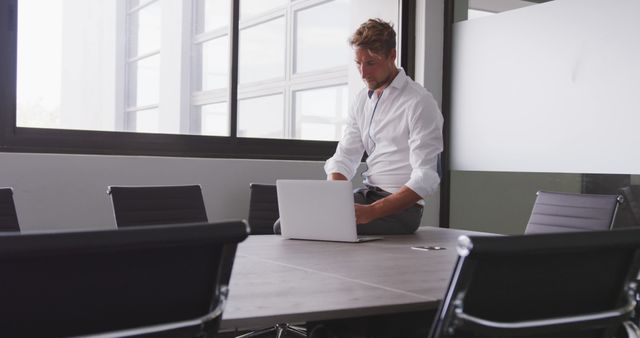 Businessman Working on Laptop in Modern Office Conference Room - Download Free Stock Images Pikwizard.com