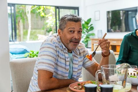 Middle-Aged Man Enjoying Healthy Meal at Home Dining Table