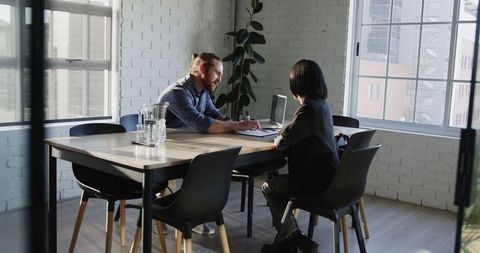 Inspiring business meeting in sunlit modern office space