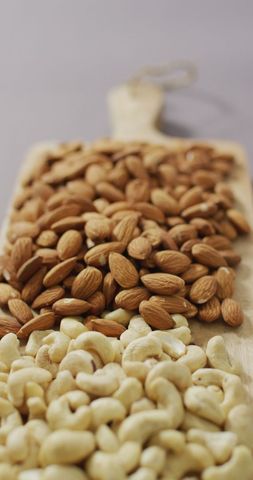 Assorted Almonds and Cashews on Wooden Board Background - Download Free Stock Images Pikwizard.com