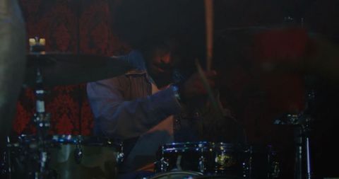 Dynamic Drummer Performing Energetic Rhythm on Stage