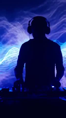 Backlit DJ Mixing on Deck with Headphones and Waveform Visuals | Vertical Club Video