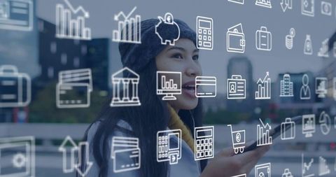 Young woman using smartphone with augmented reality finance icons over urban skyline