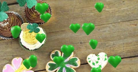Celebrating st patrick's day with shamrock cupcakes and floating green hearts