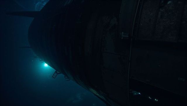 Backlit corroded ship hull revealing rivets and ladder in deep teal underwater gloom