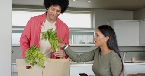 Couple Unpacking Groceries in Bright Modern Kitchen