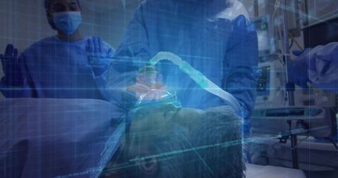 Medical Professionals Adjust Oxygen Mask in ER Surrounded by Equipment