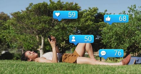 Young Woman Relaxing with Smartphone Surrounded by Social Media Icons