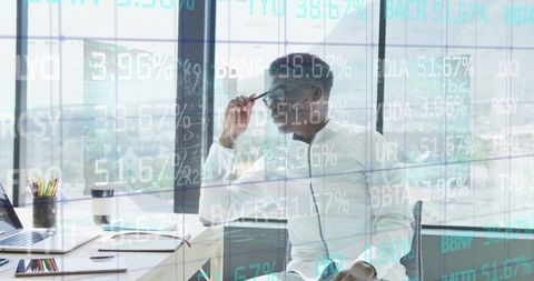 Businessman analyzing data through digital interface at workspace