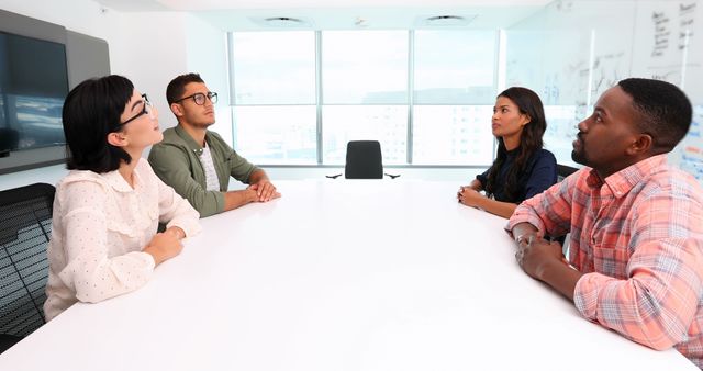 Diverse business team having a focused meeting in modern office - Download Free Stock Images Pikwizard.com