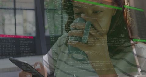 Woman holding smartphone while studying code on monitor with terminal overlay at desk