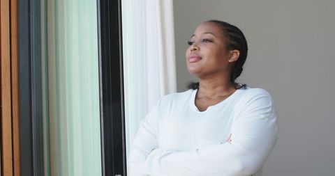 African american woman gazing through sliding door, embracing calm morning home reflection