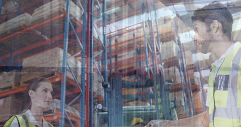 Warehouse Workers Analyzing Data in Storage Facility